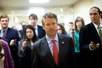 Senator Rand Paul (R-Ky.) makes his way to a weekly policy luncheon in Washington on June 11