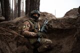 A Ukrainian soldier in a trench carries a AK-74 near