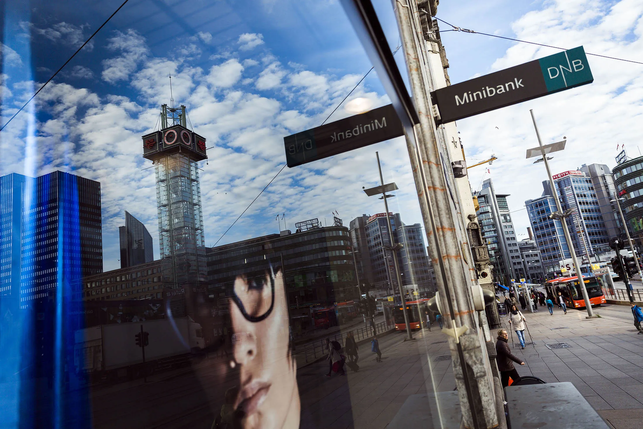 An advertisement for Marc Jacobs fashion brand sits in the window of an optical store beside a DNB ASA minibank in Oslo, Norway, on Tuesday, Oct. 6, 2015. The nation could as soon as next year start making withdrawals from its massive $830 billion sovereign wealth fund, which it has built over the past two decades as a nest egg for 'future generations.'
