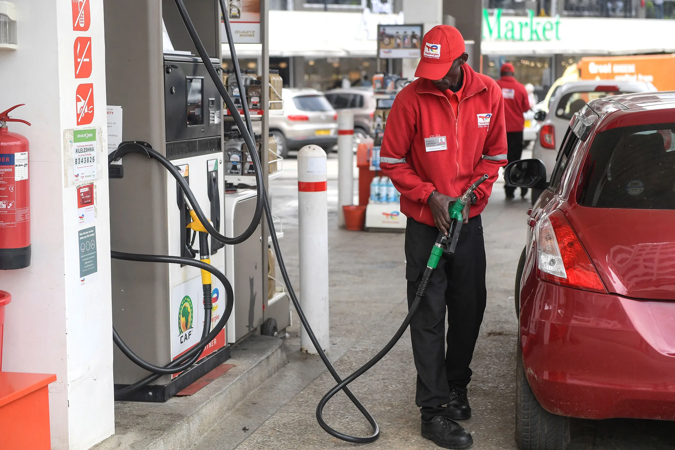 A worker fills the tank of a vehicle at a petrol station&nbsp;in&nbsp;Nairobi.