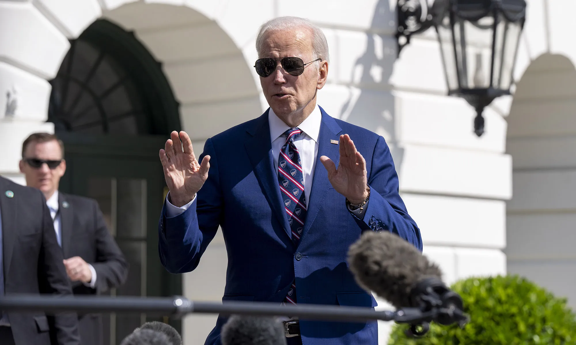 Joe Biden speaks to members of the media on the South Lawn of the White House.