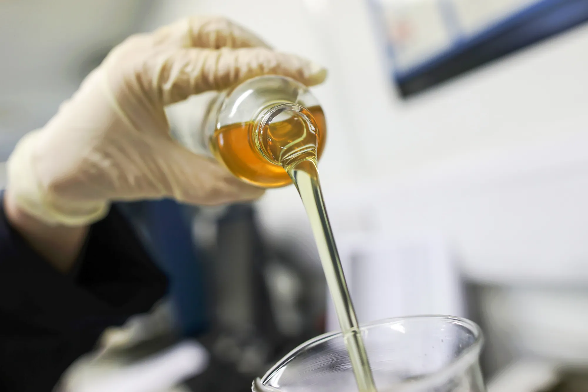 An employee pours an oil based lubricant.