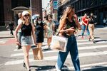 Pedestrians carrying shopping bags cross a street in the SoHo neighborhood of New York, U.S., on Wednesday, Aug. 25, 2021. 