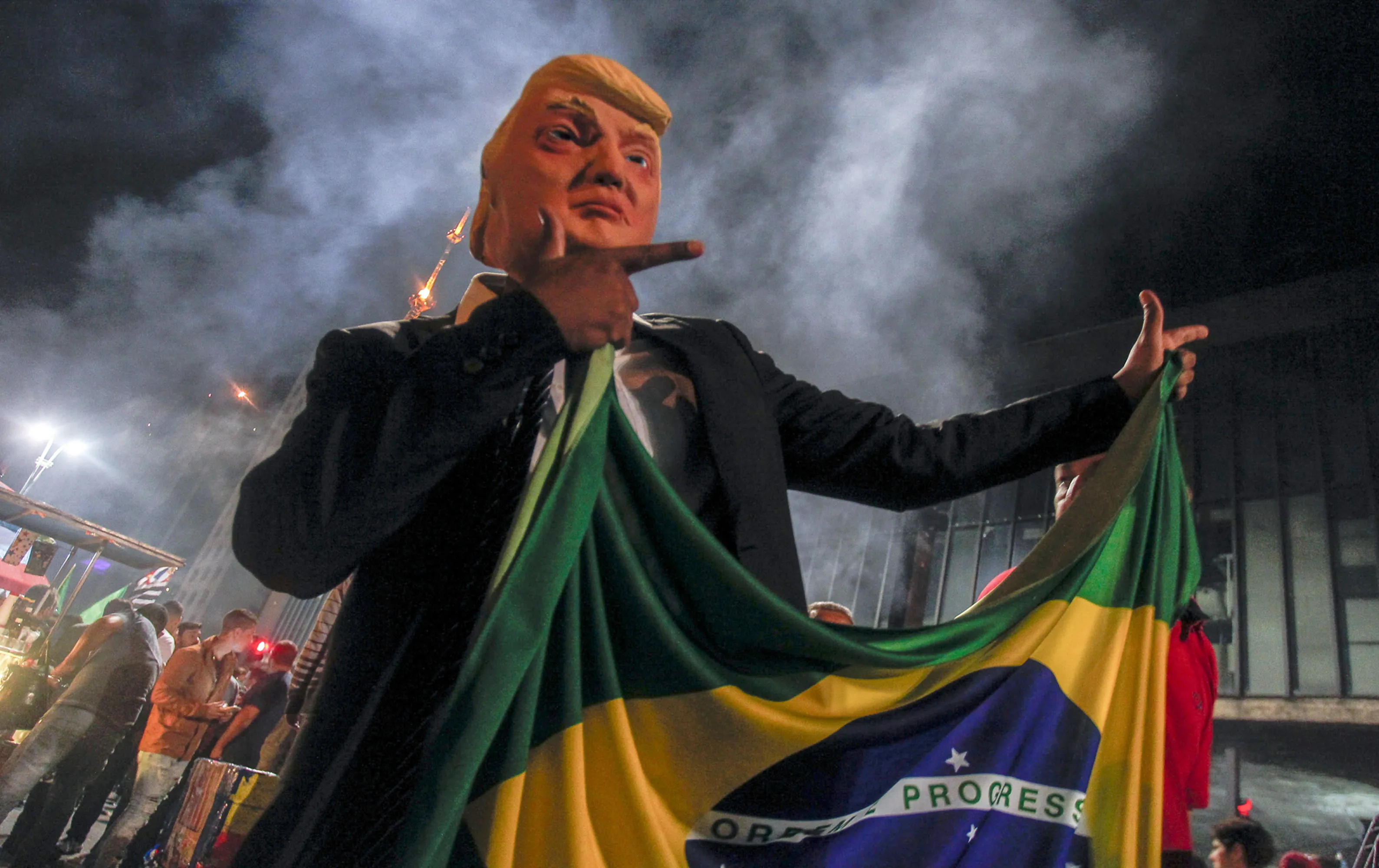 A supporter of Jair Bolsonaro wears a mask of Donald Trump as he celebrates after Bolsonaro’s election&nbsp;win&nbsp;in Sao Paulo.&nbsp;