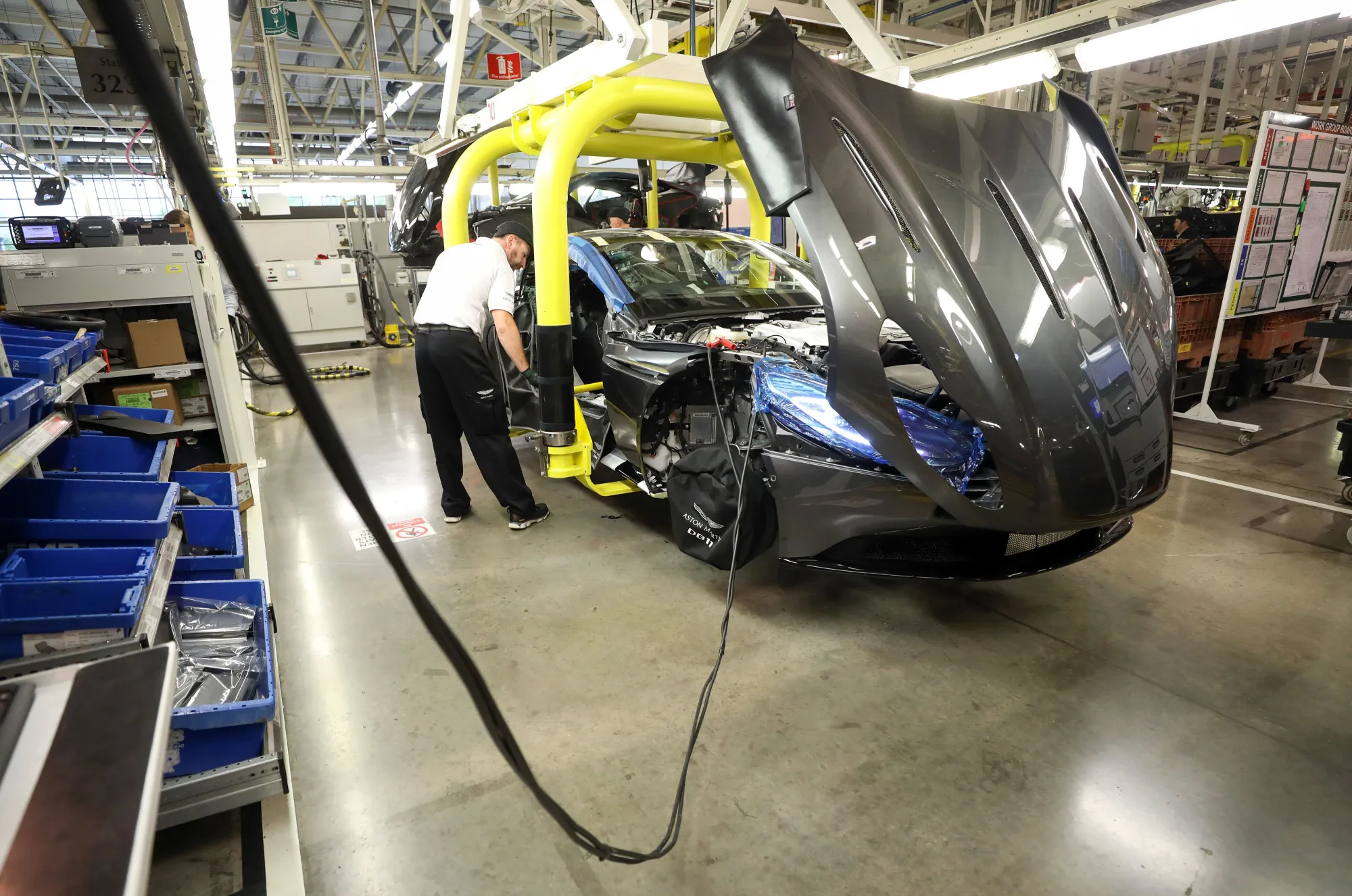 An employee checks the interior of an Aston Martin DB11&nbsp;on the final assembly line at an&nbsp;assembly plant in Gaydon, U.K.