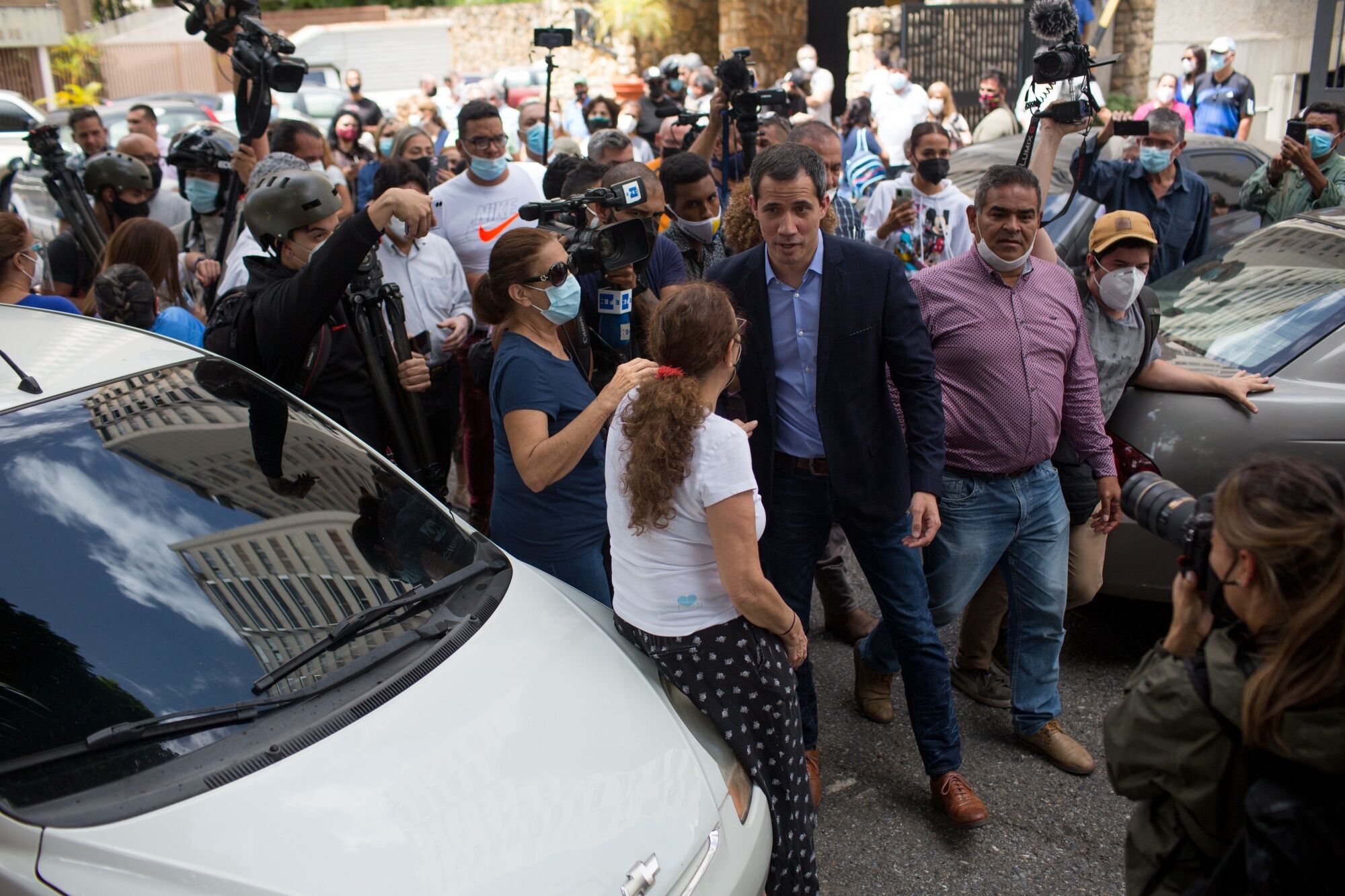 Juan Guaido speaks with members of the media outside his home in Caracas on July 12.