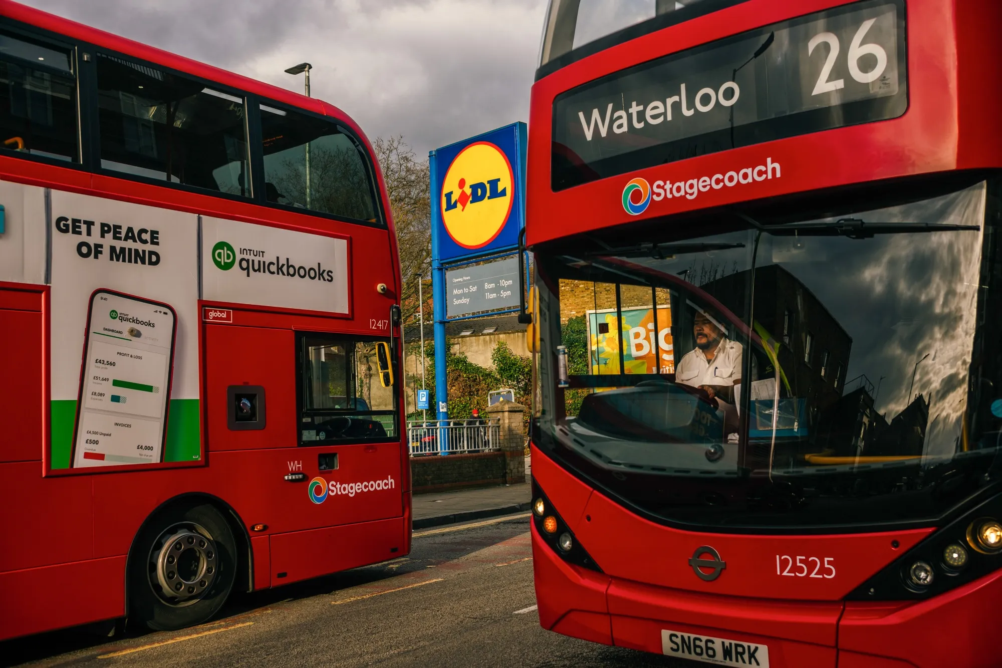 Buses pass a Lidl supermarket in Hackney, London.