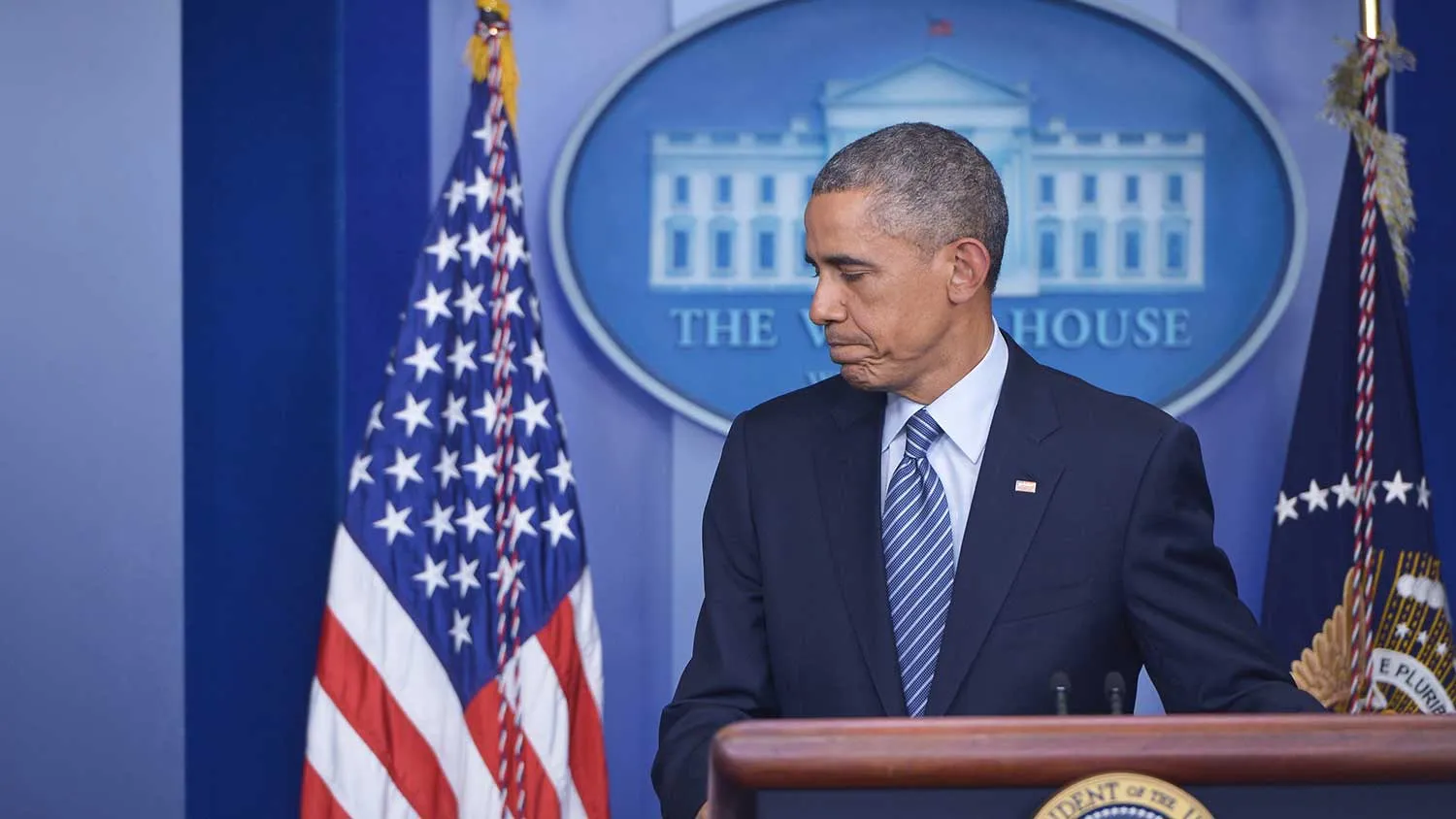 US President Barack Obama makes his way off the stage following the announcement of the decision in the case of Ferguson police officer Darren Wilson for the shooting death of teenager Michael Brown, in the Brady Briefing Room of the White House on November 24, 2014 in Washington, DC.
