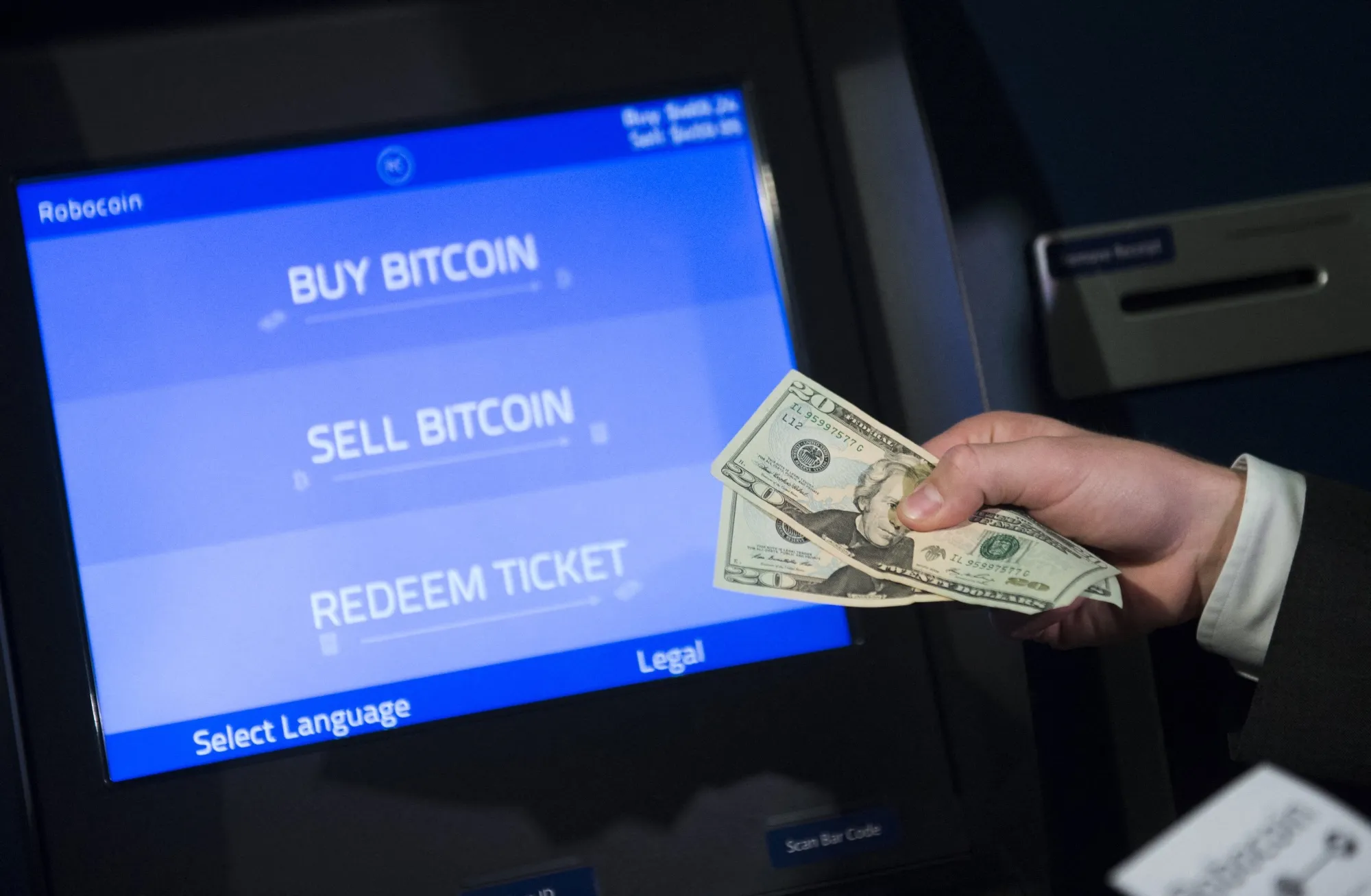 A person uses a Robocoin kiosk to buy cryptocurrency in Washington DC.