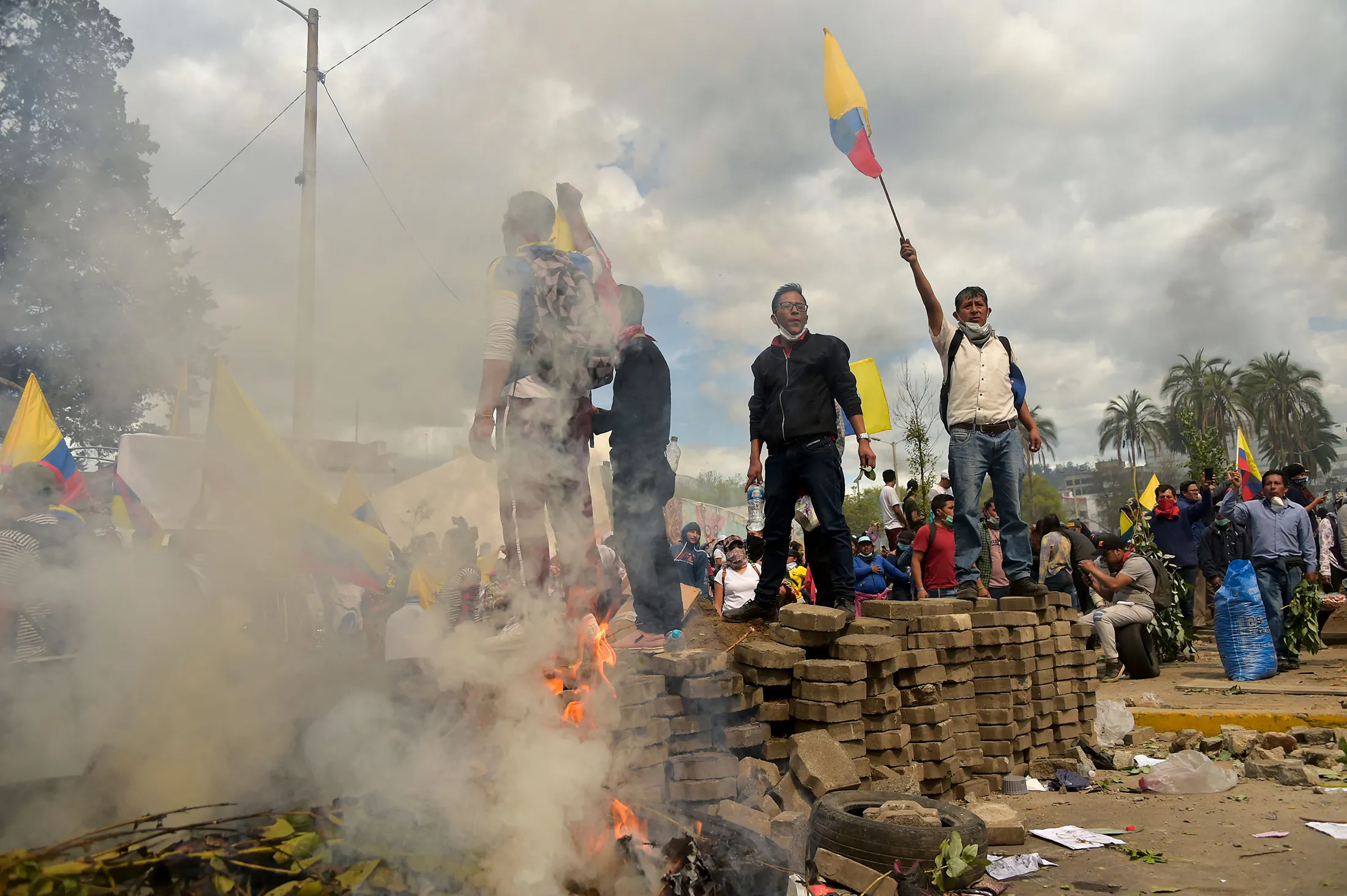 Demonstrators stand a top a barricade during the 10th day of a protest in Quito on Oct. 12.