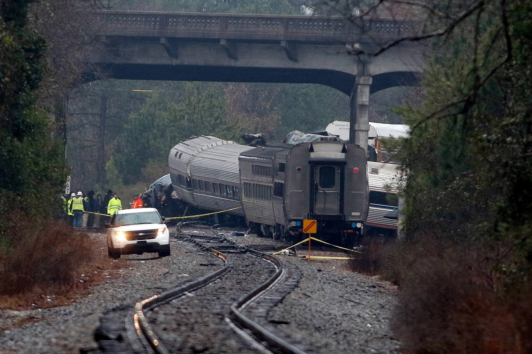 Investigators make their way around train wreckage in Cayce, South Carolina.