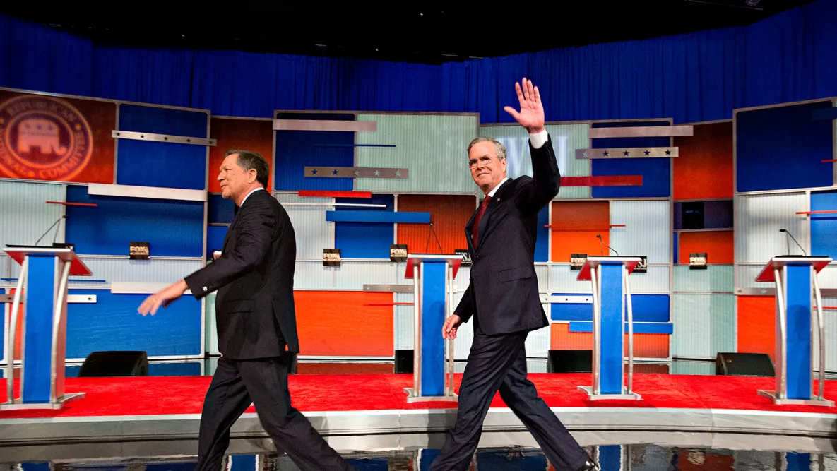 Jeb Bush waves as he arrives on stage with John Kasich during a presidential debate in Milwaukee, Wisconsin, on Nov. 10, 2015.
