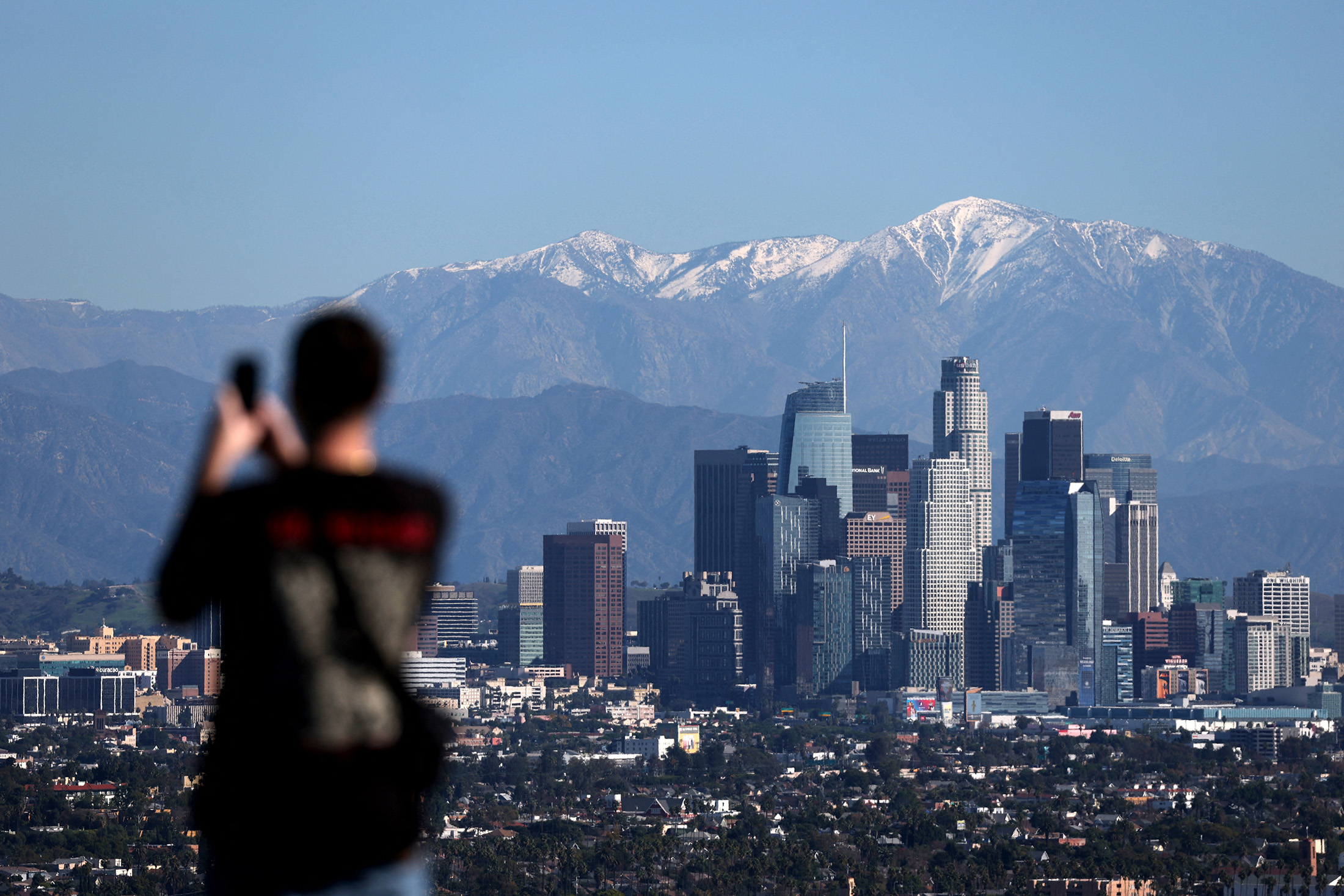 The San Gabriel Mountains above the Los Angeles skyline in Los Angeles, California, on Dec. 4, 2025. Photographer: Patrick T. Fallon/AFP/Getty Images