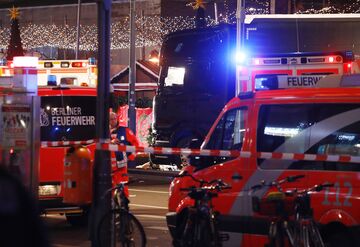Police and firefighters are working next to the truck that crashed into a christmas market at Gedächniskirche church in Berlin, on Dec.19, 2016 killing at least nine people. 
