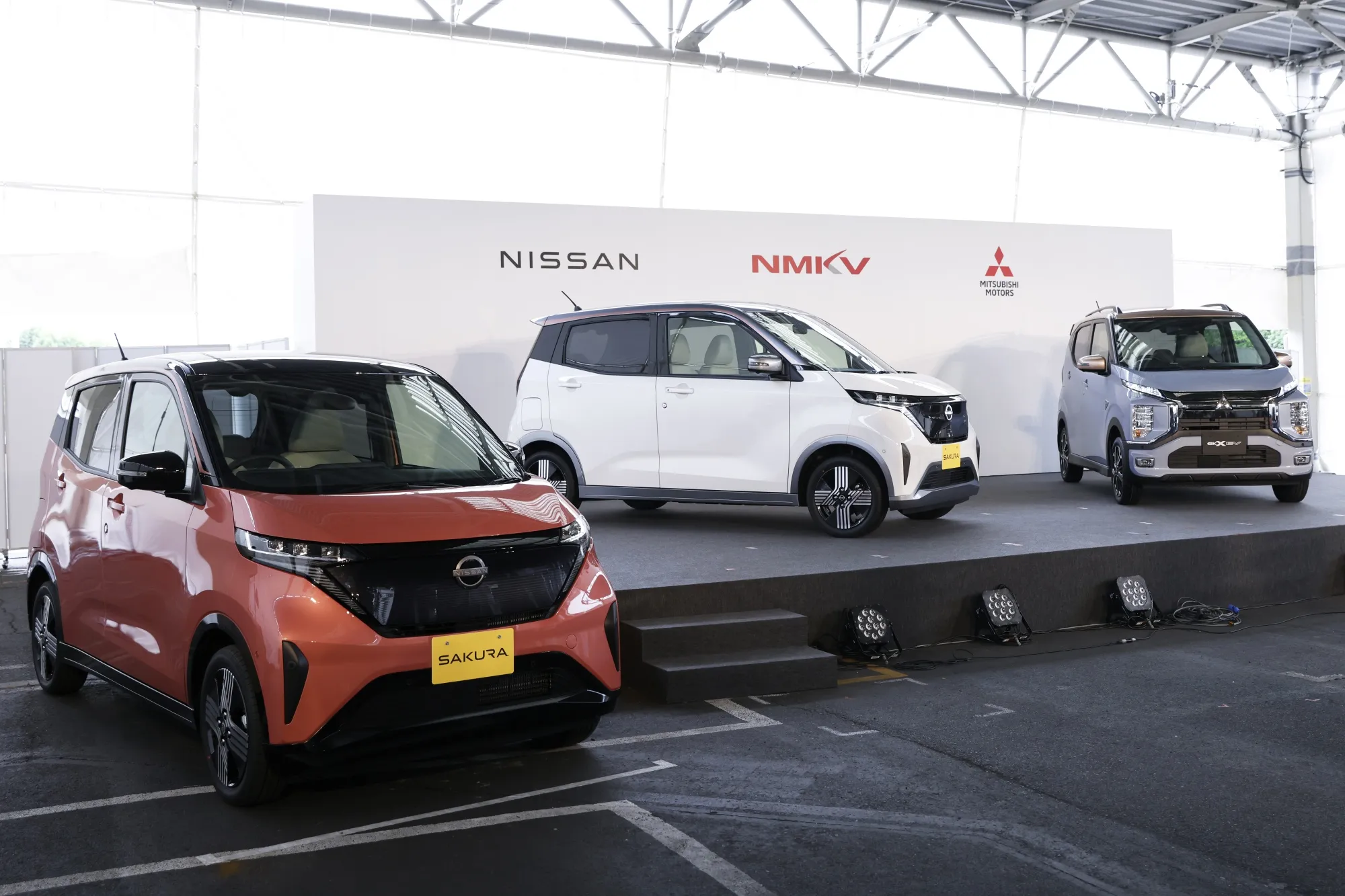 Nissan Motor Co. Sakura electric vehicles, left and center, and a Mitsubishi Motors Corp. eK X electric vehicles.
