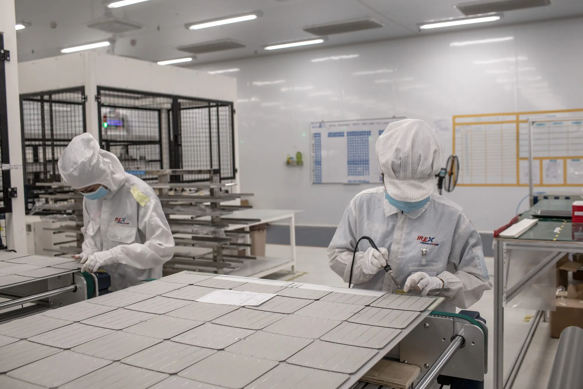 Workers solder photovoltaic cells at a manufacturing facility in Vung Tau, Vietnam.