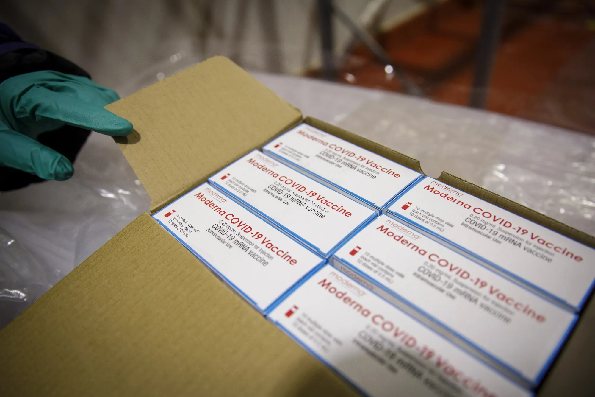 Boxes of the Moderna Inc. Covid-19 vaccine in a freezer room.
