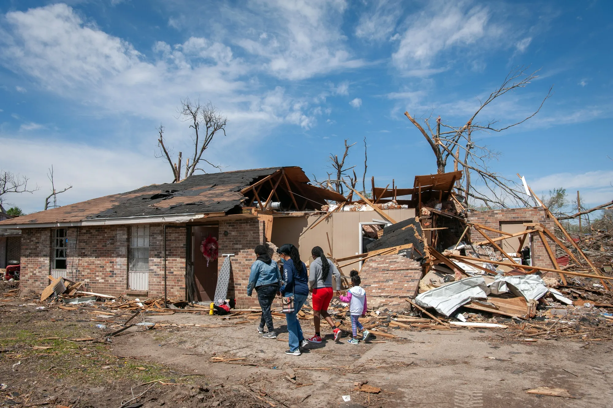 A family visits their destroyed home following a tornado in Rolling Fork, Mississippi, in March.&nbsp;