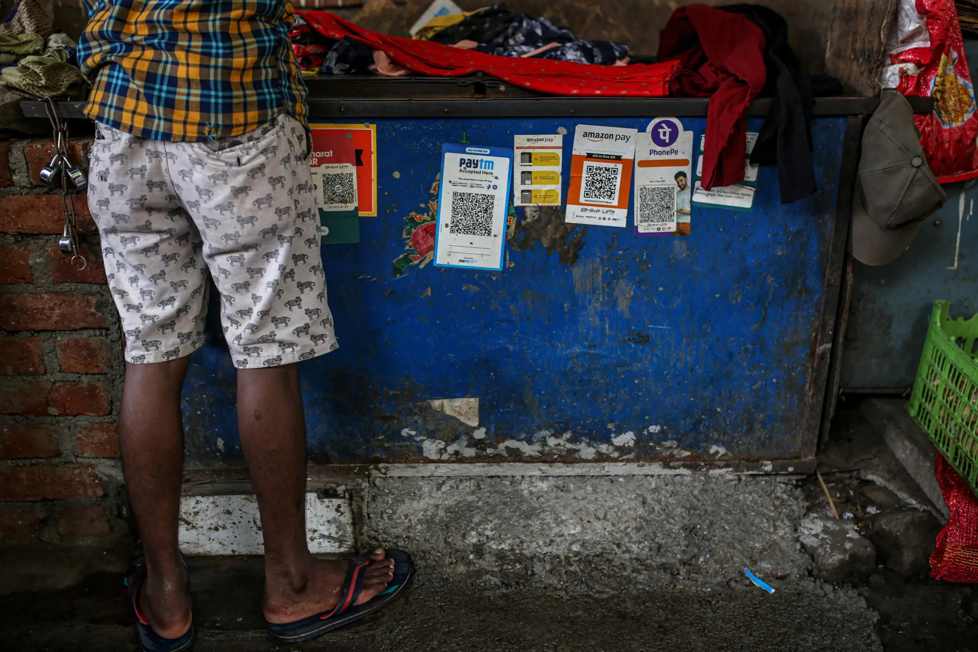A store advertises the use of various digital payment systems in Mumbai, India.