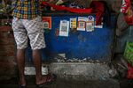 A store advertises the use of various digital payment systems in Mumbai, India.