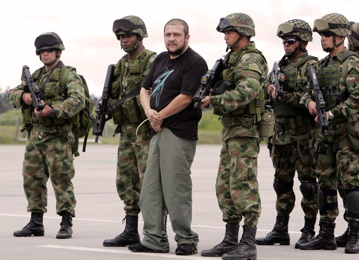 Convicted drug kingpin Diego Leon Montoya Sanchez, center, in thecustody of Colombian soldiers in 2007.