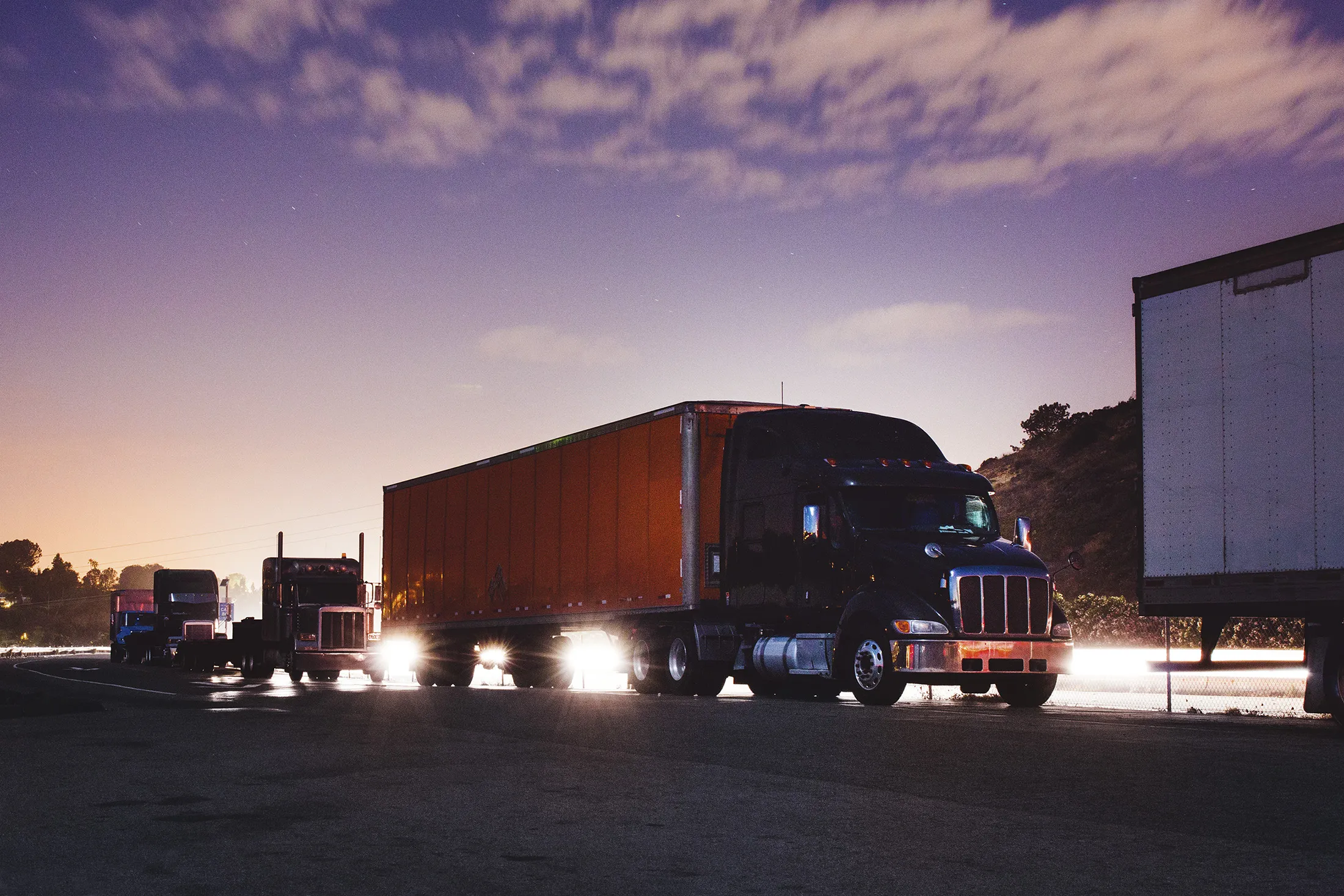 Trucks parked by the side of the freeway.