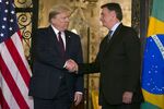 Trump, left, shakes hands with Jair Bolsonaro at Mar-a-Lago resort in Palm Beach, Florida, U.S., on Saturday, March 7, 2020. 