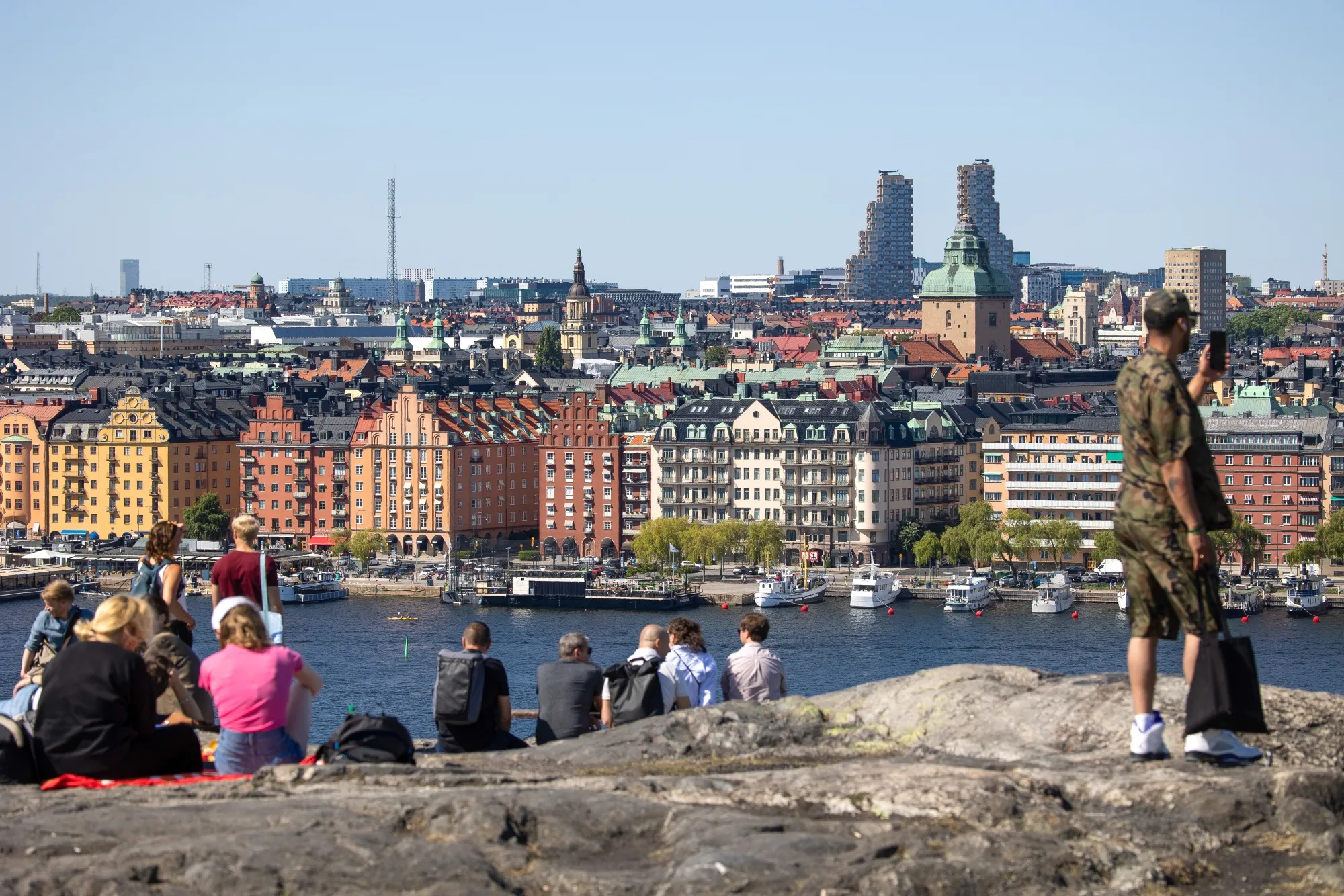 Visitors at a viewpoint overlooking the city skyline in Stockholm.