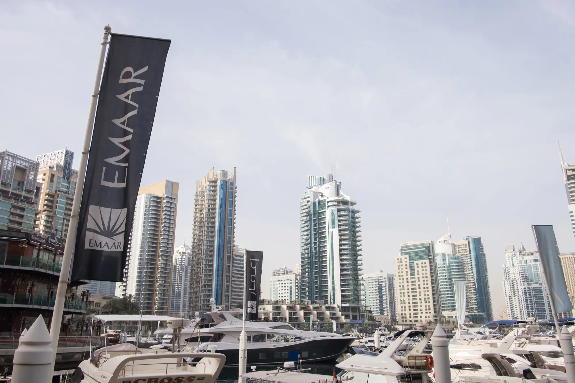 A banner advertising Emaar Properties PJSC flies in the harbor at Dubai Marina in Dubai.