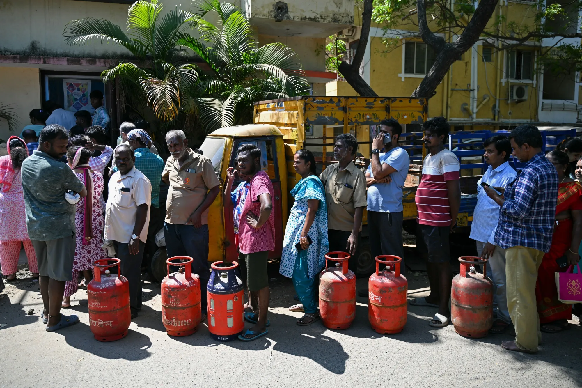 People queue to buy liquefied petroleum gas cylinders for domestic use in Chennai on March 11.