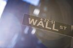 A Wall Street sign is displayed in front of New York Stock Exchange (NYSE) in New York.