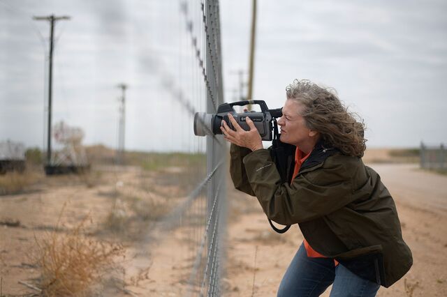 Sharon Wilson points her infrared camera at a tank battery on the outskirts of Midland, Texas.