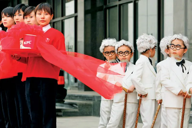 Chicken without borders: Children dress up like Colonel Sanders at a Beijing KFC opening