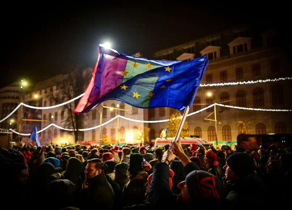 Demonstrators hold EU and Romanian national flags during a pro-European rally in Bucharest.