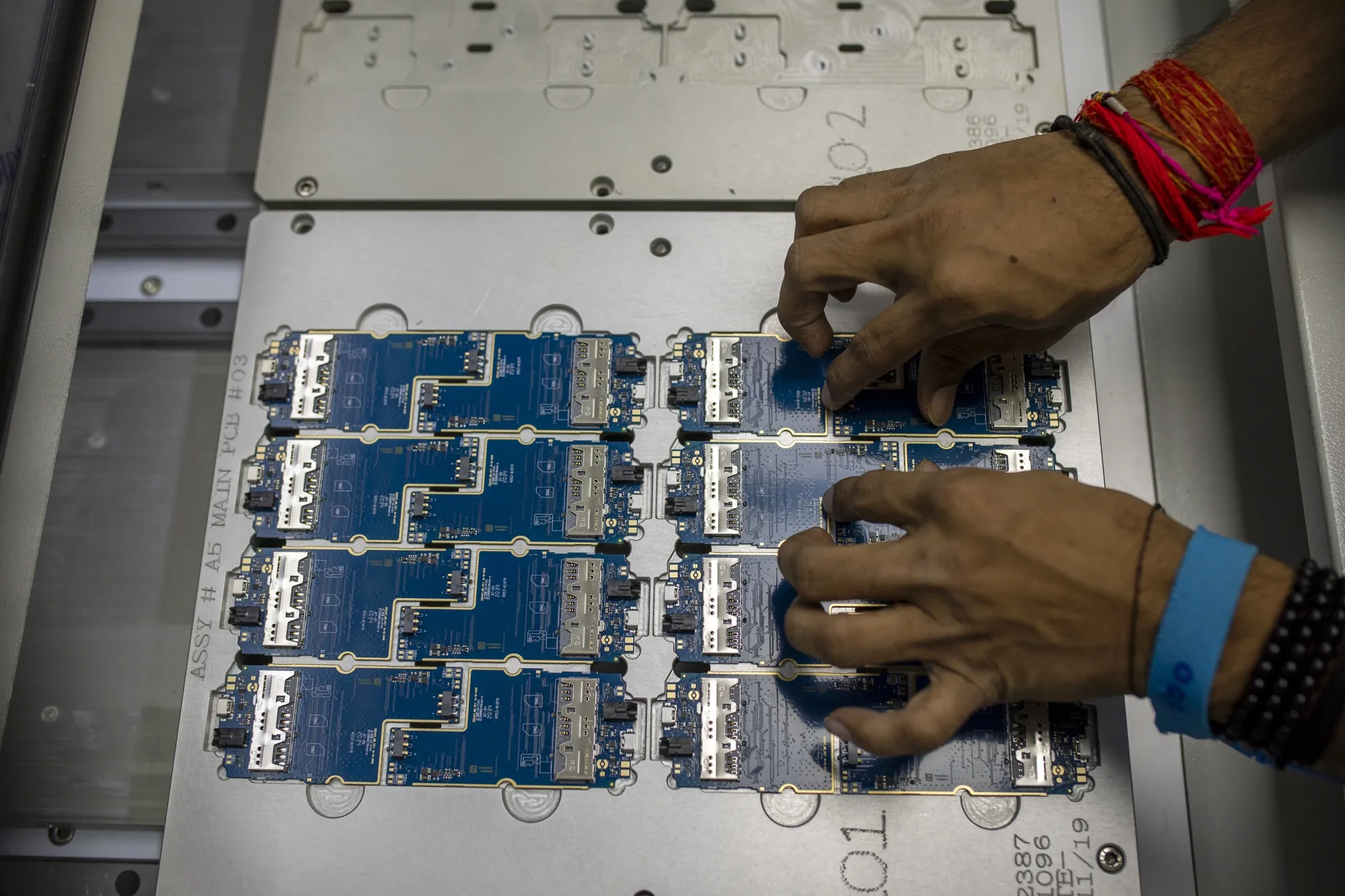 A worker prepares circuit boards at a&nbsp;factory in Noida, India.