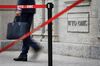 A delegate leaves a World Trade Organisation (WTO) building during the 2018 edition of the WTO public forum on sustainable trade, on October 2, 2018 at the WTO headquarters in Geneva. (Photo by Fabrice COFFRINI / AFP) (Photo credit should read FABRICE COFFRINI/AFP/Getty Images)