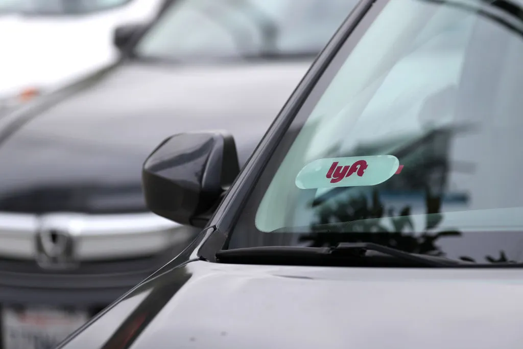The Lyft logo is displayed on a car in San Francisco.