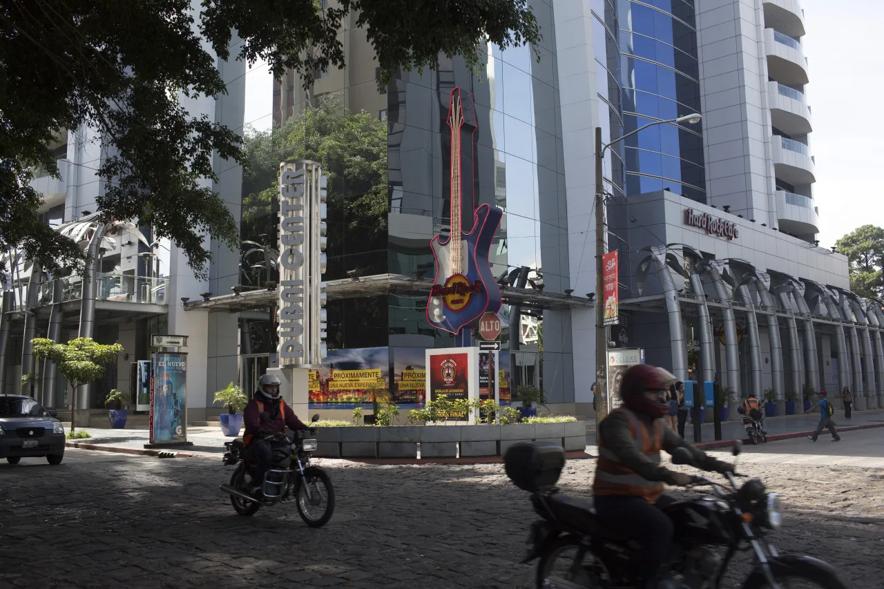 Men on motorcycles drive in the business district&nbsp;in Guatemala City.&nbsp;