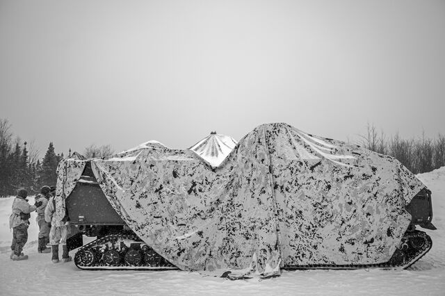 A camouflage tarp covers a CATV.