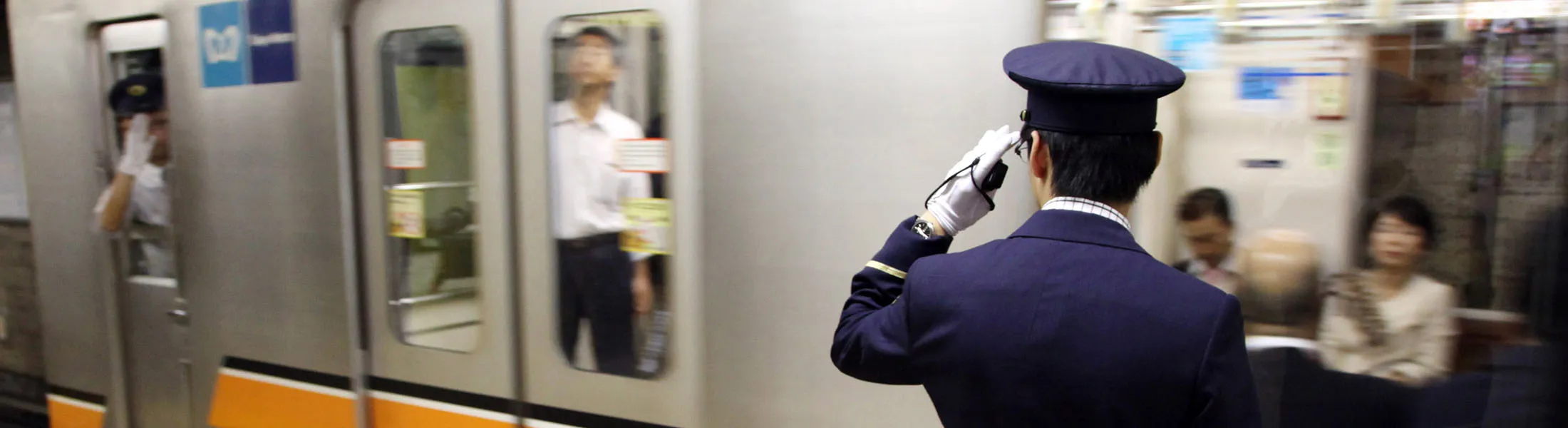 A Tokyo Metro Co. employee works as a subway train leaves a station in Tokyo, Japan, on Wednesday, Oct. 5, 2011. Japan's government may sell a stake in the subway system to help fund reconstruction following the March 11 earthquake and tsunami, Finance Minister Jun Azumi said on Sept. 5.