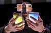 An attendee holds the Samsung Electronics Co. Galaxy S10, left, and the Galaxy S10+ during the Samsung Unpacked launch event in San Francisco.