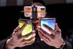 An attendee holds the Samsung Electronics Co. Galaxy S10, left, and the Galaxy S10+ during the Samsung Unpacked launch event in San Francisco.
