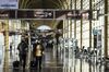 Travelers wearing protective masks walk through Ronald Reagan National Airport (DCA) in Arlington, Virginia, U.S., on Wednesday, Nov. 25, 2020. While passenger volumes are less than 40% of last year’s levels, late demand for holiday travel has been driven by fares that are substantially lower than typical as airlines desperately try to fill seats during the coronavirus pandemic.