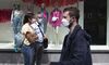 People wearing protective masks wait in line to enter store in Montreal, Quebec, Canada, last year.