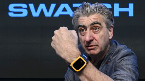 Swatch Group CEO Nick Hayek with the Swatch Touch Zero One wristwatch.