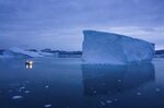 A boat navigates at night next to large icebergs in eastern Greenland on Aug. 15, 2019. Zombie ice from the massive Greenland ice sheet will eventually raise global sea level by at least 10 inches (27 centimeters) on its own, according to a study released Monday, Aug. 29, 2022.  Zombie or doomed ice is still attached to thicker areas of ice, but it’s no longer getting fed by those larger glaciers.  (AP Photo/Felipe Dana)