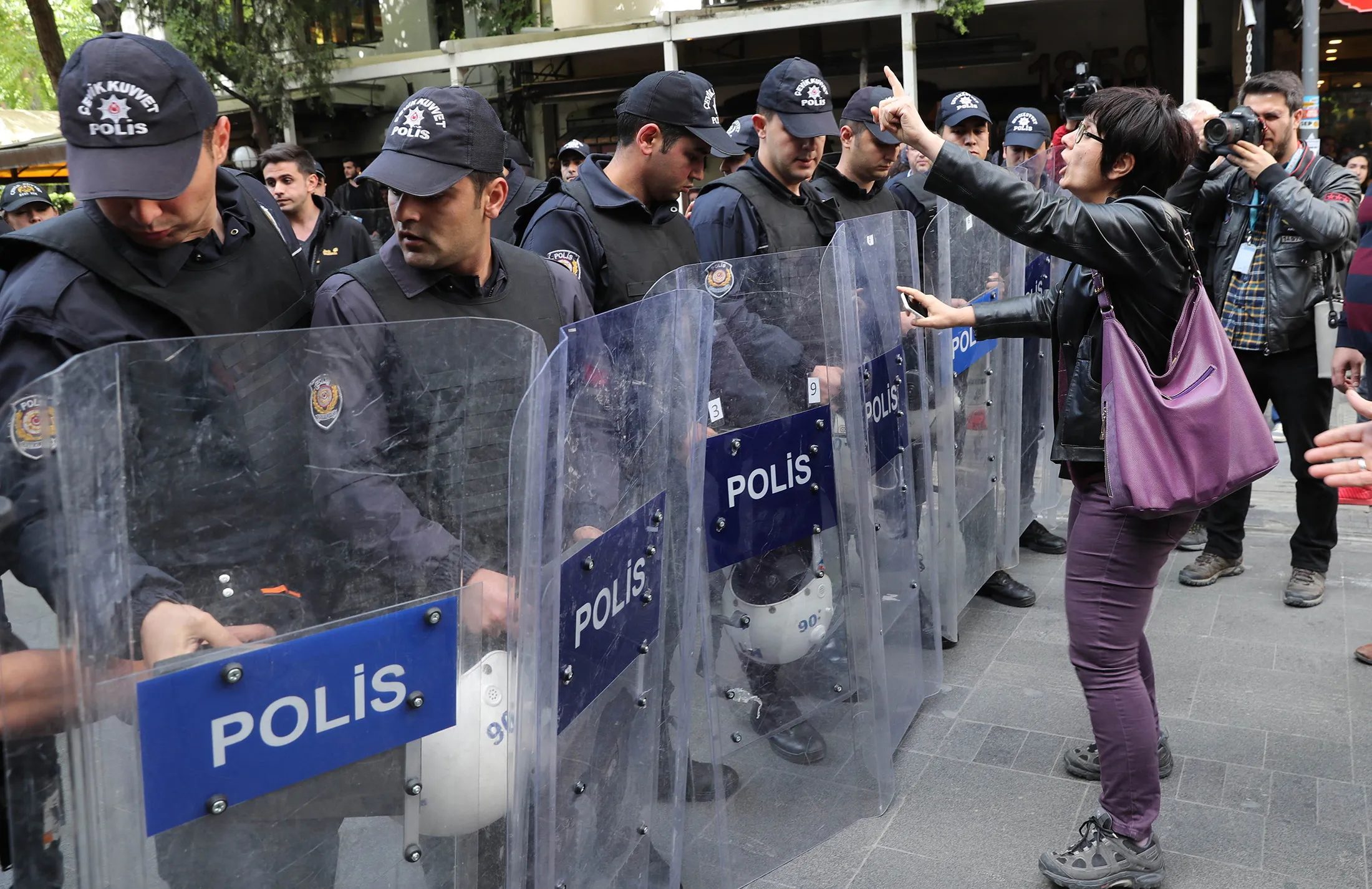 A protester stands in front of police during a demonstration in Ankara, on May 22, 2017.

