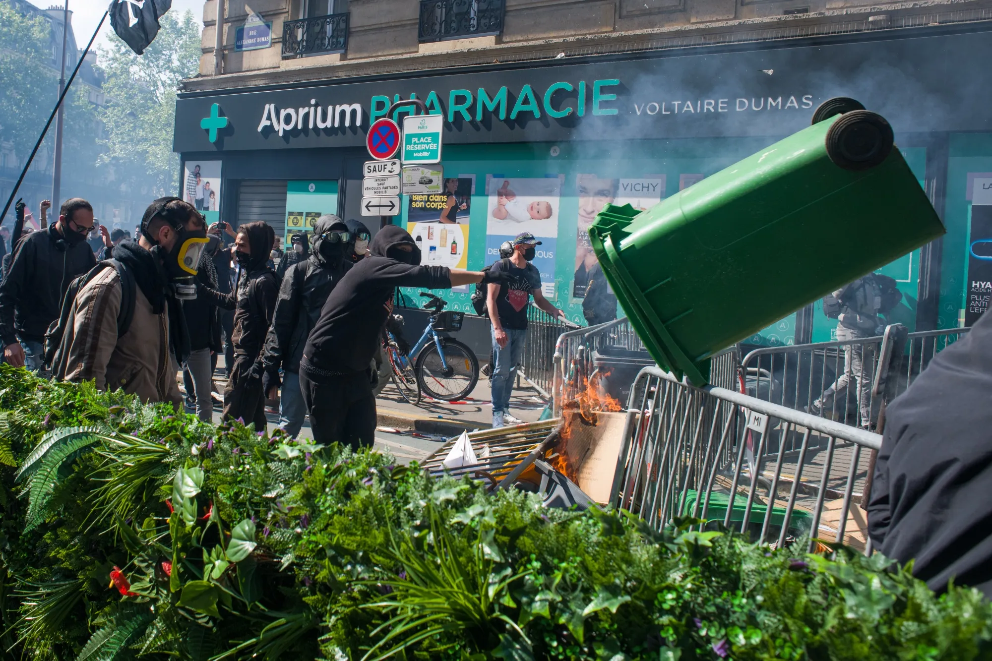 A protester throws a rubbish bin over a barricade during May Day demonstrations in Paris, France, on May 1.