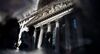 Pedestrians are reflected in a puddle while passing in front of the New York Stock Exchange (NYSE) in New York, U.S., on Friday, May 19, 2017. U.S. equities advanced at the end of a turbulent week as corporate results and a rally in commodities fueled optimism in the world's largest economy.