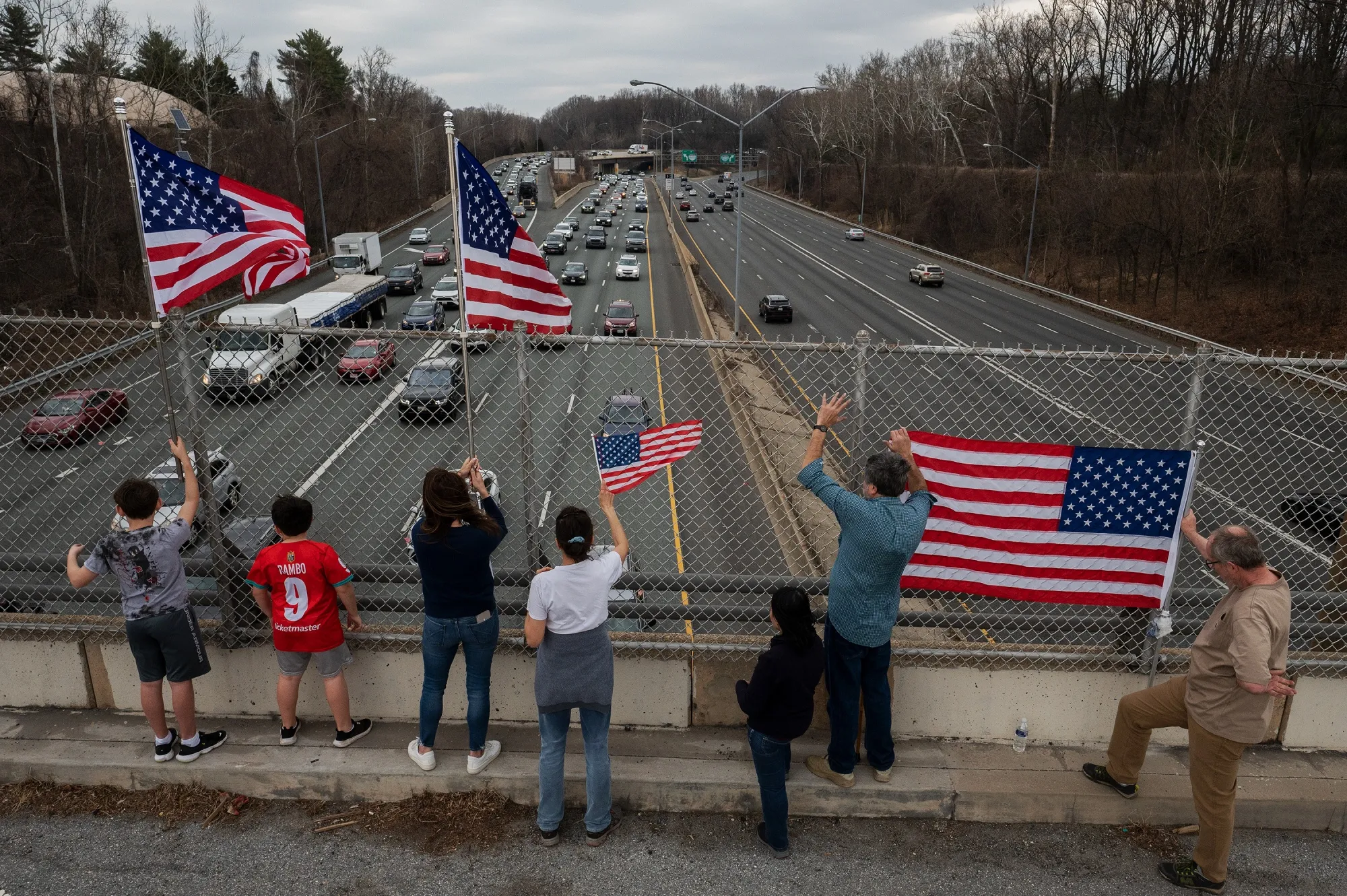 Demonstrators wave American flags as trucks circle the Washington Beltway during “The People’s Convoy” event in Maryland, on March 6.